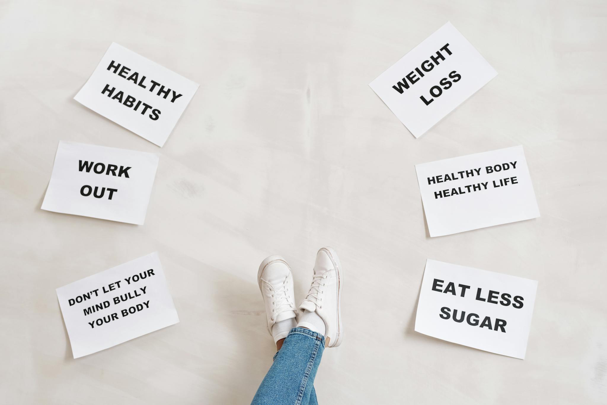 Inspirational health and fitness messages with shoe-clad feet, promoting healthy habits and wellbeing.