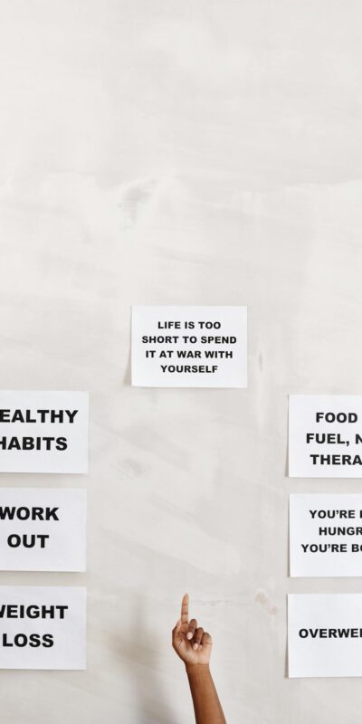 Motivational signs promoting healthy habits and self-awareness with pointing hand.