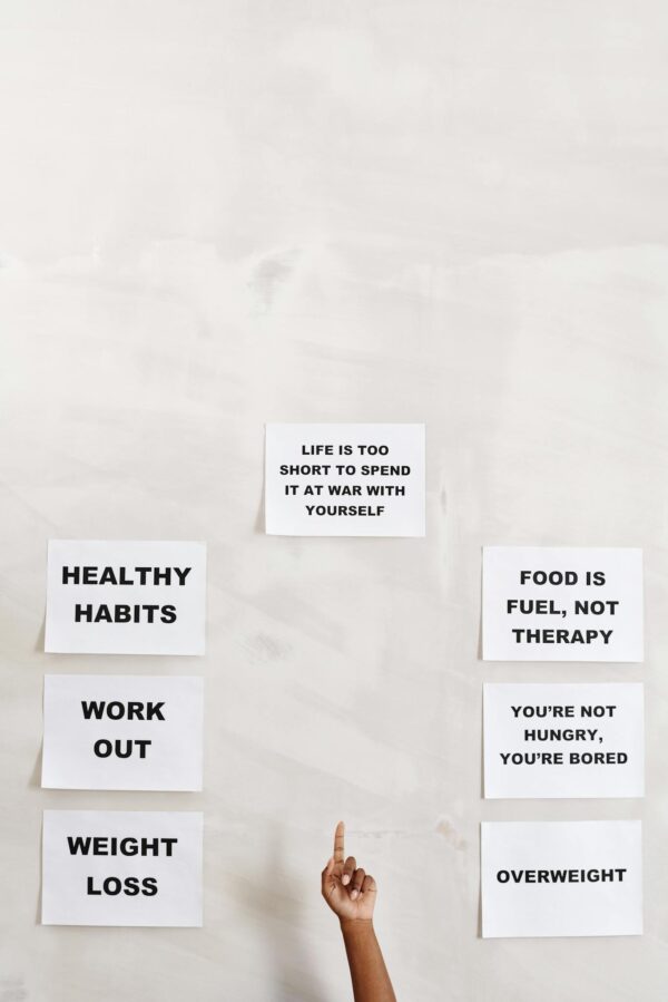 Motivational signs promoting healthy habits and self-awareness with pointing hand.