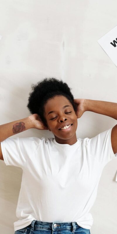 Smiling woman embracing positive lifestyle with healthy living messages around her.